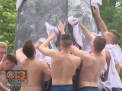 Shirtless Navy Freshmen Celebrate Summer with Climb Up Greasy Monument