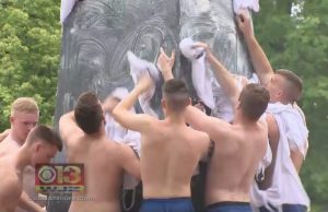 Shirtless Navy Freshmen Celebrate Summer with Climb Up Greasy Monument